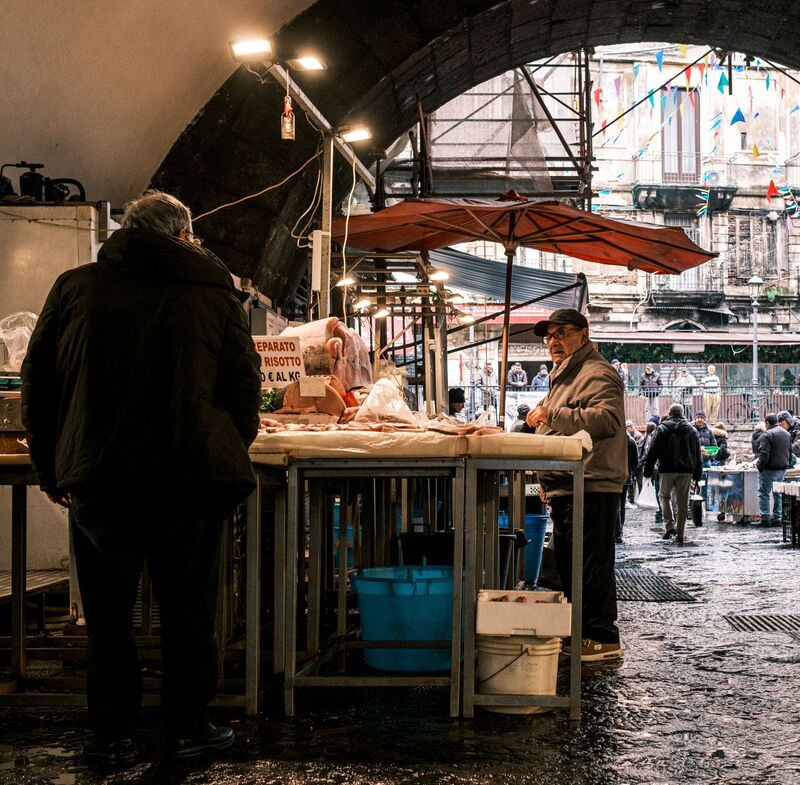 Interior do Mercado de Campo de Ourique, em Lisboa, com bancas de restauração e produtos locais